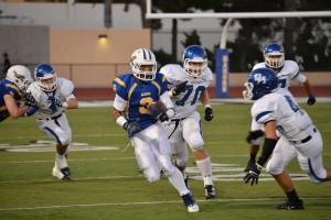 Baron Isaiah Davis ('14) runs with the ball. Photo by Tue Duong