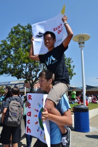 Reach Out member rides on the shoulder of another student to gain attention. Photo by Kristie Hoang.