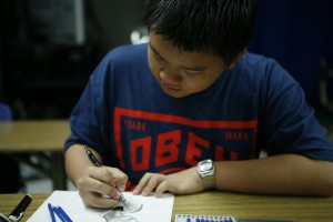 Ryan Chu ('15) sketches his entry for the contest.