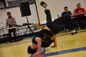 Alan To ('15) captivates the crowd by landing baby freeze. Photo by Tue Duong