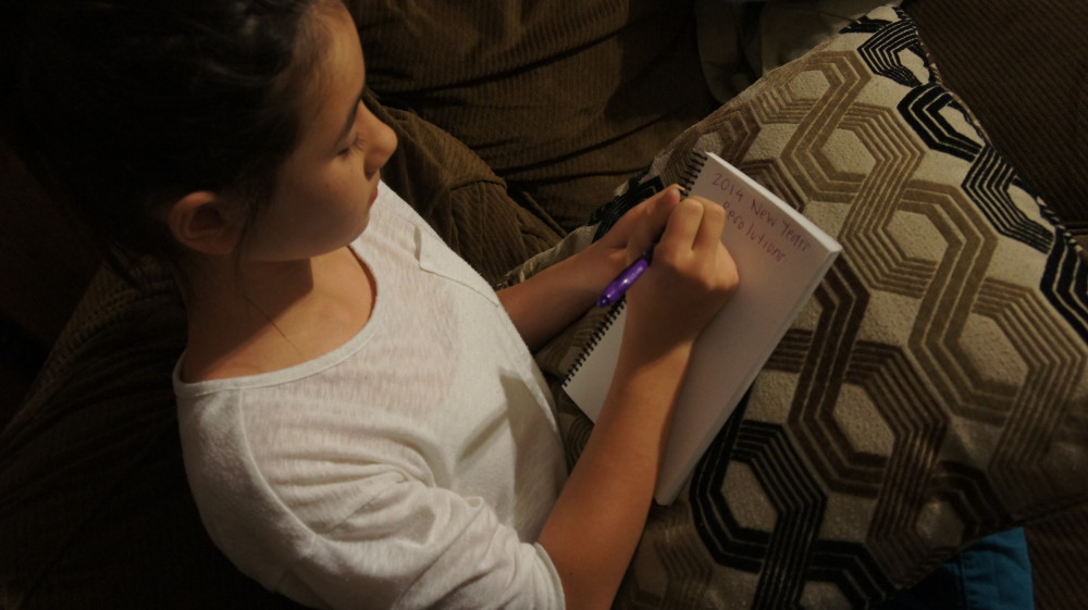 Student prepares New Year's Resolution list for the new year. Photo by Katrya Ly