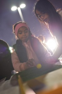 Elaine Nguyen ('16) helps in organizing game booths during the event. Photo by Ashley Le.