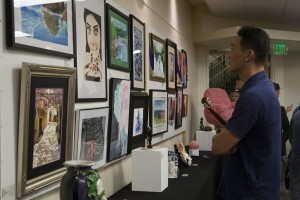 A parent views the various arts at the show. Photo by Alex Doan
