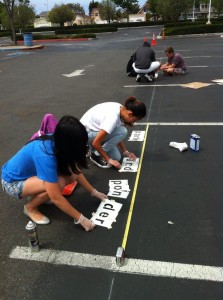 The group spray paints the parking lot using stencils during Spring Break. Photo provided by @ParkAndPonder via Twitter