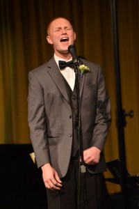 Michael Querry ('14) performs a solo with the troubadors. Photo by Tue Duong