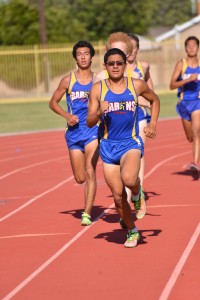 Kenneth Barios ('15) leads the boys in the 200-meter race. Photo by Tue Duong.