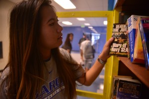 Tammy Peng ('16) checks out the book booth during passing period. Photo by Ashley Le