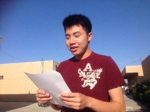 Martin Tran ('15) practices his audition song nearby the choir room. Photo by Naomi Nguyen. 