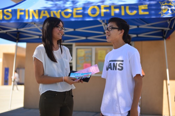 Vivian Bui ('15) exchanges information with Danny Ho ('16) after purchasing her homecoming ticket. Photo by Ashley Le. 