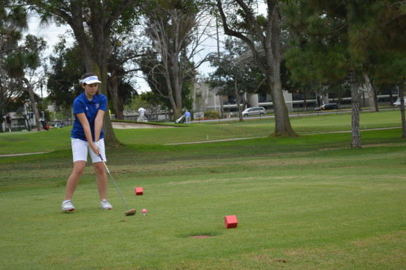 Nichelle Nakasu (16) prepares for her shot on the first hole. Photo by Mackenzie Hill