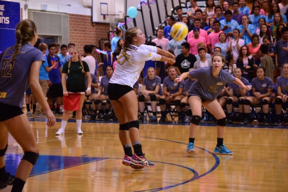Libero Ari Jacobsen ('15) sets the ball for her teammate. Photo by Ashley Le.