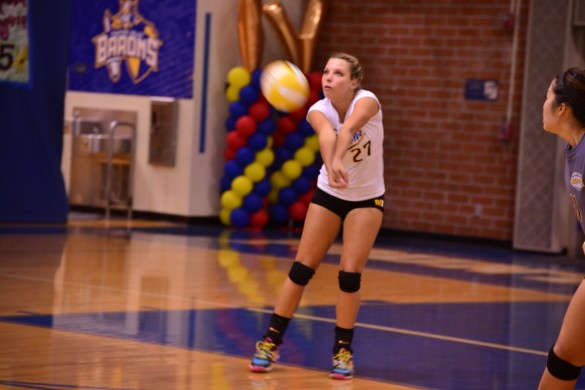 Libero Ari Jacobsen ('15) passes the ball to set up an offensive play. Photo by Ashley Le.