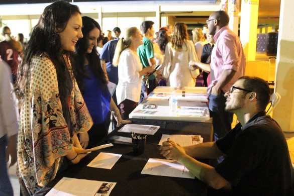 A representative gives curious students information about his college. Photo by Andy Kim