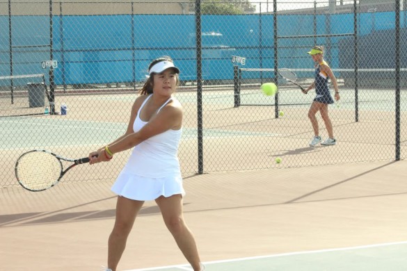 Giao Phan ('16) prepares for a backhand to return the ball during the doubles match. Photo by Chris Wells.