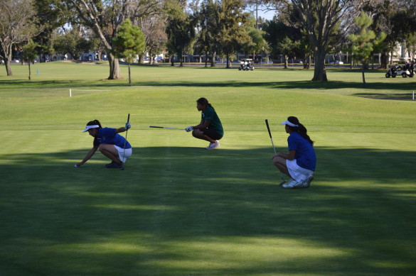 Emily Bui ('16) and Vivienne Nguyen ('15) prepare to putt on their second game against Edison. Photo by Mackenzie Hill
