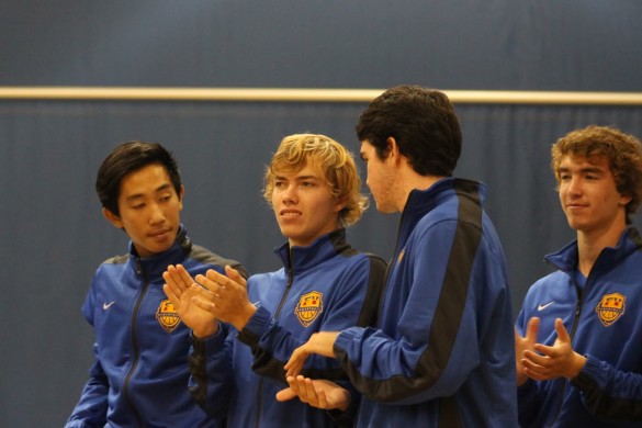 Varisty players, Vincent Nguyen, Luke Jacobsen,Chris Meyer, and James Philhower applaud after guess speaker delivers inspirational speech. Photo by Chris Wells.