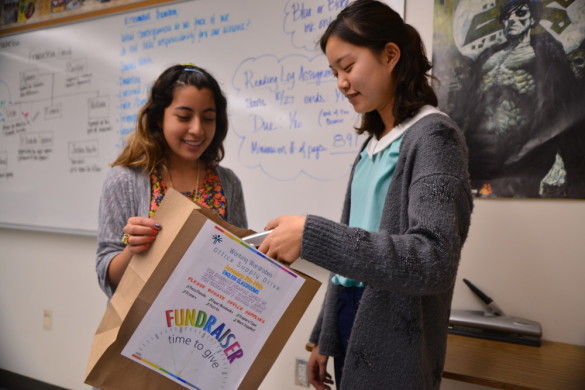 Alexis Sutterman ('15) and Joyce Yoo participated in the office supply drive in their English classroom. Photo by Ashley Le. 