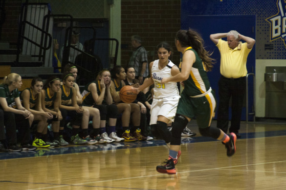 Andie Kristinat ('17) dribbles downs the court confronting a Charger