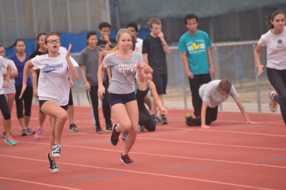 Members of the boys and girls track team share the track during practice. Photo by Ashley Le