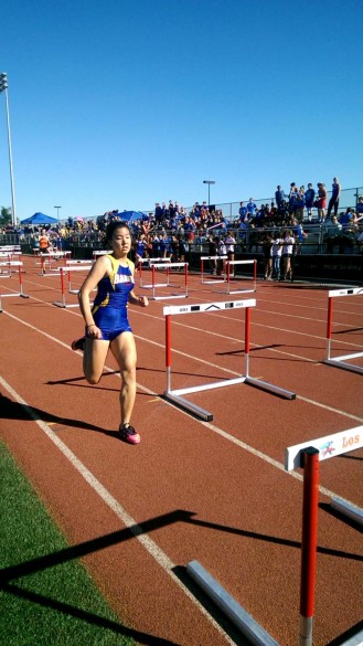 Davina Pham ('16) starts the Shuttle Hurdle Relay Race. Photo by James Nguyen.