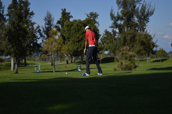 Player Jesse Mooney ('16) shoots on the first hole. Photo by Mackenzie Hill