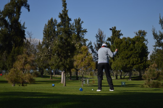 Player Bailey Duda ('15) swings on the first hole. Photo by Mackenzie Hill. 