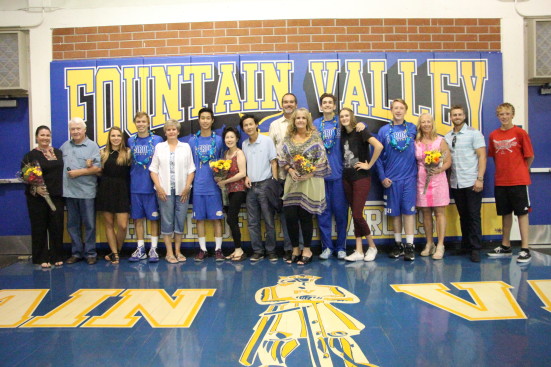 Seniors pose with their loved ones at their last home game. Photo by Andy Kim