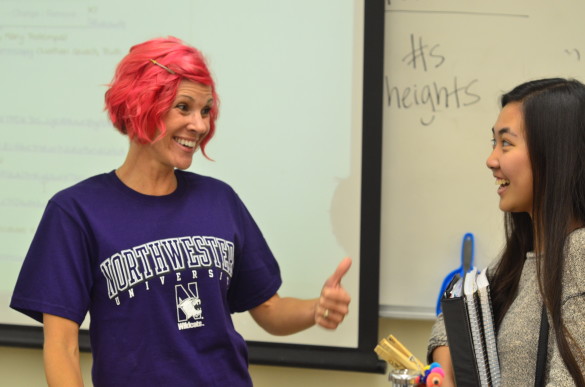 Biology teacher Emily Barro talks about colleges to Emily Tran ('17) while wearing a Northwestern University t-shirt. 