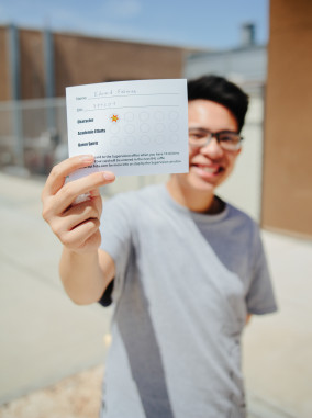 Ethan Le ('16) happily shows off a sticker earned by teacher recognition of character.