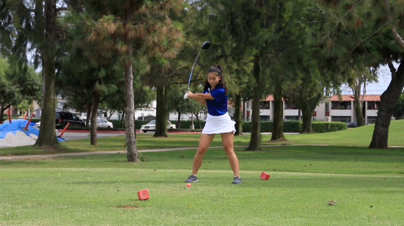 "Varsity captain Emily Bui ('16) swings on her first hole of the match. Photo by Mackenzie Hill." 