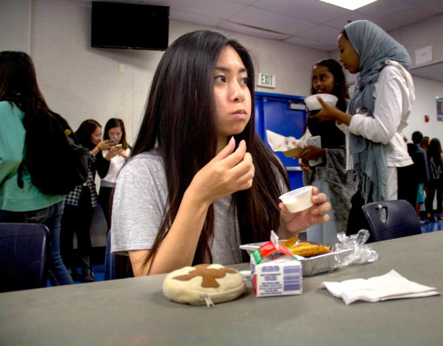Kathy Le ('16) is eating chicken nuggets in the cafeteria Photo by Viet Vu