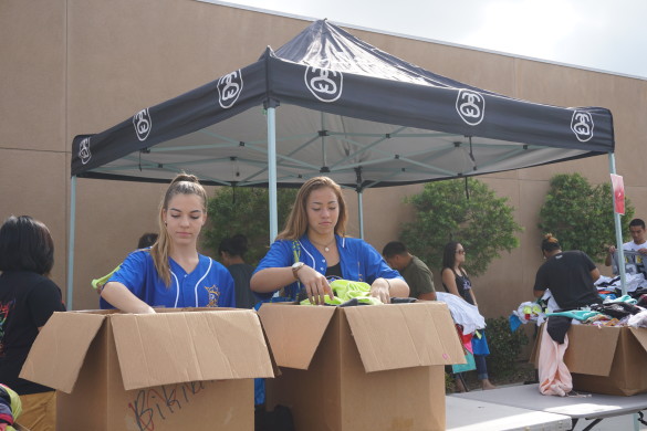 Emma Lyall ('16) and Rebecca Schoon ('18) organize the clothes from Stussy