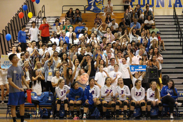 Loud Crowd shows their support for girls volleyball during the White Out game. Photo by Michelle Nhi Nguyen