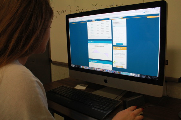 Katherine Reis ('16) checks her stock market portfolio in her economics class. Photo by Viet Vu.
