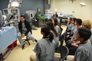 Medical Society members listen to Instructor Carlos Gomez-Mustafa introducing the Da Vinci Robot