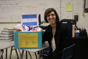 CP English 2 teacher, Dawn Lawler poses next to her "You are what you learn" supply drive for kids in Honduras. Photo by Sandra On. 