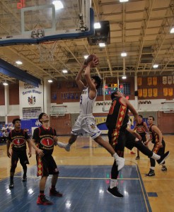 Sean Huynh ('17) gets around Segerstrom's defense for a layup. Photo by Julia Pacis
