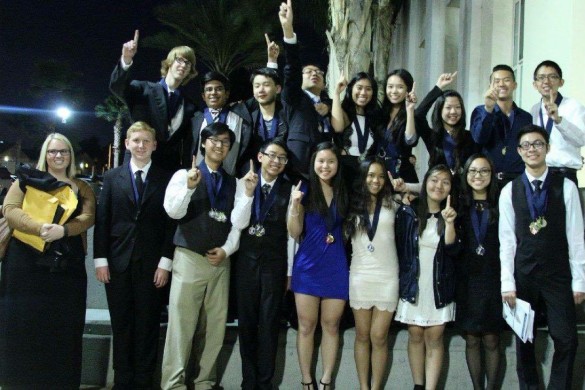 Academic Decathlon holds up their index finger to symbolize their first place win. Photo courtesy of Fiona Tsang ('17).