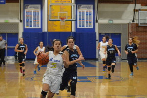 Ruth Nguyen ('16) dribbles the ball towards the basket 