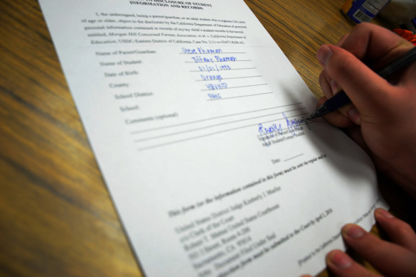 Student signs the disclosure form. Photo Illustration by Steve Phan