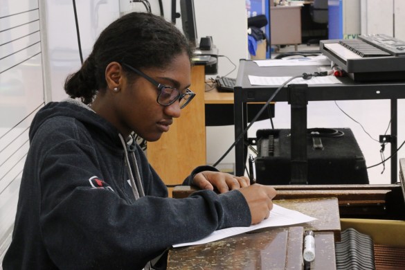 Ericka Greene ('17) fills out the interest form for the potential music technology course. Photo by Bridget Ton 