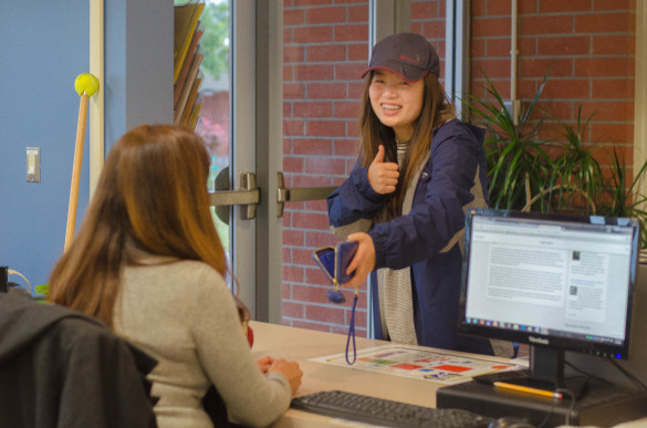 Senior Nicole Vuong pays for her senior expenses. Photo illustration by Steve Phan.