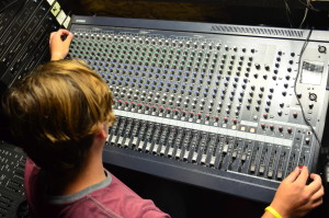 Crew member Caleb Nehrbass ('17) sets up the sound board for "The Wizard of Oz." Photo by Steve Phan.