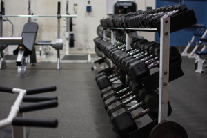The athletics department replaced the old weight room equipments with new dumbbells. Photo by: Alex Tran 