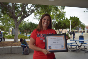 Sharon Tait poses with her big smile and the 2016 Classified School Employee of the Year Award 