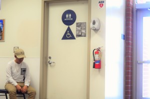 Ash Diep ('17) waits for his turn to use the only gender neutral and single stalled bathroom at Fountain Valley High School. Photo by Steve Phan.