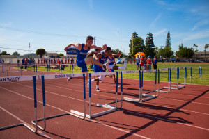 ( ????) jumps a hurdle during FVHS's track meet against Los Al, keeping his 1st place lead in his event. Photo by Michelle Nhi Nguyen