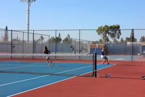 Kayla Korhonen ('17) prepares for a backhand as Jane Nguyen ('17) runs to cover the forehand side. Photo by Ivy Duong.