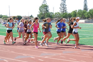 Runners jogging in a pack of the girls' 800 meter. Photo by Elise Tran