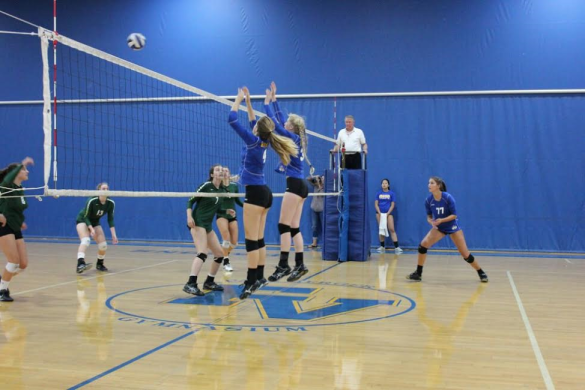 Barons Jenna Everson (18) and Phoebe Minch (20) attempting to block a Charger hit.
